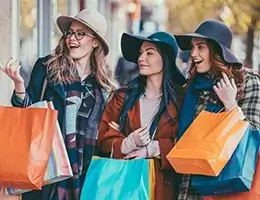 three young women shopping