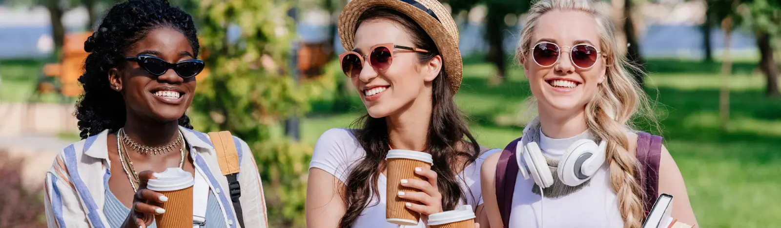 Three women outside with coffee